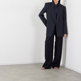 Model wearing The Frankie Shop navy shirt, styled with matching wide-leg trousers and an oversized blazer in dark navy.