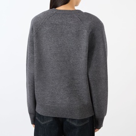 Model wearing The Frankie Shop dark grey wool-blend crew neck sweater, back view, styled with dark denim jeans.