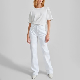 Model wearing The Frankie Shop Dalston Straight Leg Jeans in white, high-rise straight leg fit with contrast stitching, styled with a white T-shirt