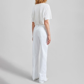 Model wearing The Frankie Shop Dalston Straight Leg Jeans in white, high-rise straight leg fit, styled with a white cropped tee, rear view