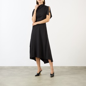 Model wearing Victoria Beckham black midi dress with high neck, split cap sleeves and asymmetric hem, styled with black heeled mules