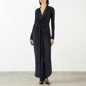 Model wearing Victoria Beckham Lea Gathered Wrap Dress in navy with draped V-neckline, long sleeves, gathered side detail and subtle sheen finish