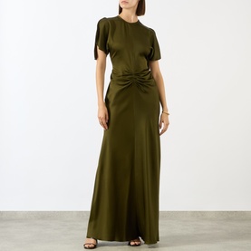 Model wearing Victoria Beckham Dark Green satin gown with ruched waist, short split sleeves, and floor-length skirt, styled with black heeled sandals.