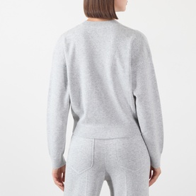 Model wearing Victoria Beckham Grey Marl merino wool cashmere blend crew-neck sweater, styled with matching grey marl joggers, rear view.
