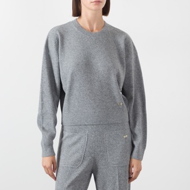 Model wearing Victoria Beckham Mid Grey Marl merino wool cashmere crew neck sweatshirt, styled with matching grey marl joggers.