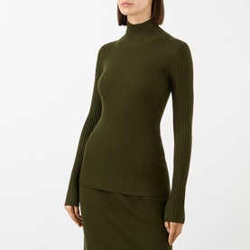 Model wearing Victoria Beckham Logo Rib-Knit Turtleneck Sweater in Dark Green, styled with matching ribbed midi skirt