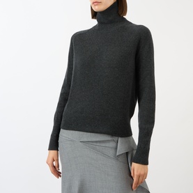 Model wearing Victoria Beckham Marie Turtleneck Sweater in dark grey wool with ribbed trims, styled with a grey midi skirt
