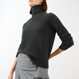 Model wearing Victoria Beckham Marie Turtleneck Sweater in dark grey wool, styled with grey trousers