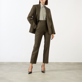 Model wearing Victoria Beckham Patch Pocket Striped Shirt, styled with olive tailored blazer, matching trousers and black heels.