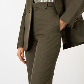 Model wearing Victoria Beckham Straight Leg Cropped Trousers in Gold wool, high-rise with pressed creases, styled with matching blazer and stripe