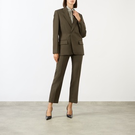 Model wearing Victoria Beckham Straight Leg Cropped Trousers in Gold wool, styled with matching blazer, printed shirt, and black heels