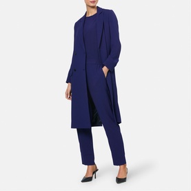 Model wearing Helen McAlinden Ink Blue long open-front coat styled with matching top and tailored trousers, black heels