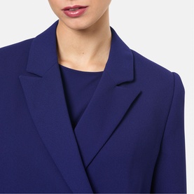 Model wearing Helen McAlinden Ink Blue blazer with matching crew-neck top, close-up of lapel and neckline detail.