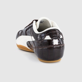 Dark brown croc-embossed leather trainer, white heel counter and side stripe, gum rubber sole, rear three-quarter view