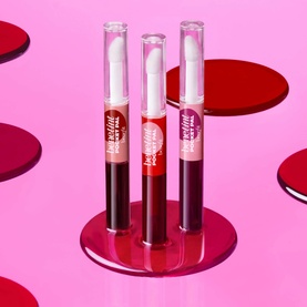 Benefit Benetint Pocket Pal lip glosses in Original Rose and red shades, three dual-ended clear tubes displayed upright on pink background
