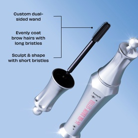 Benefit dual-sided brow wand with long bristles to coat and short bristles to sculpt, shown against a light blue background