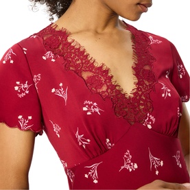 Model wearing Whistles red floral print dress with lace V-neckline trim and short sleeves, close-up detail shot