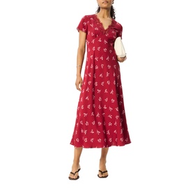 Model wearing Whistles red floral midi dress with V-neck and short sleeves, styled with white clutch bag and black sandals.
