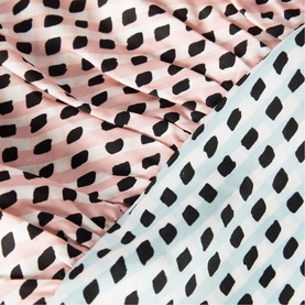 Whistles pink scarf with black brushstroke dot print, shown alongside a pale blue version of the same design.