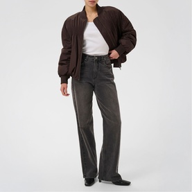 Model wearing Kaffe Arlette Cropped Bomber Jacket in Coffee Bean, styled with white tee and grey wide-leg jeans.