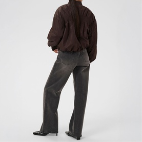 Model wearing Kaffe Arlette Cropped Bomber Jacket in Coffee Bean, styled with grey wide-leg jeans and black heeled boots, back view.