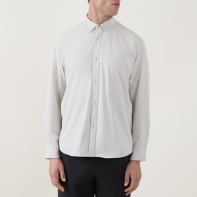 Model wearing Snow Peak ivory casual shirt with button-down collar and long sleeves, styled with black trousers