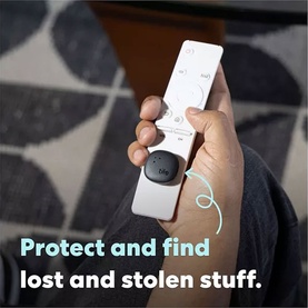 Hand holding a TV remote with a small black tile tracking device attached, with text overlay reading Protect and find lost and stolen stuff