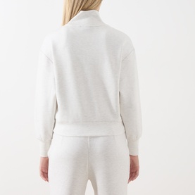 Model wearing Varley Ivory Marl sweatshirt, back view, shown with matching joggers in the same fabric.