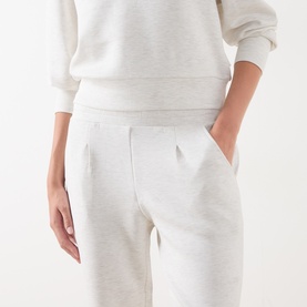 Model wearing Varley Ivory Marl sweatpants with elasticated waistband and front pockets, styled with matching sweatshirt
