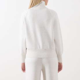 Model wearing Varley Ivory Marl sweatshirt, back view, turtleneck, long sleeves, styled with matching wide-leg joggers.