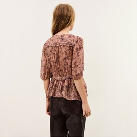 Model wearing Bash pink floral chiffon blouse with puff sleeves, ruffle collar and elasticated waist, styled with dark trousers