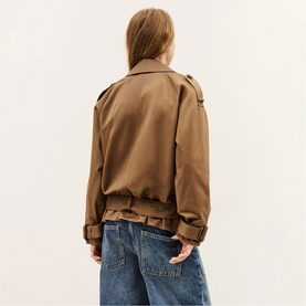 Model wearing Bash brown cropped jacket, back view, styled with wide-leg blue jeans