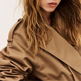 Model wearing Bash brown trench coat, close-up detail of wide lapel collar and shoulder epaulette