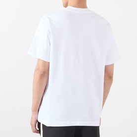 Model wearing white oversized crew-neck T-shirt, rear view showing dropped shoulders and short sleeves