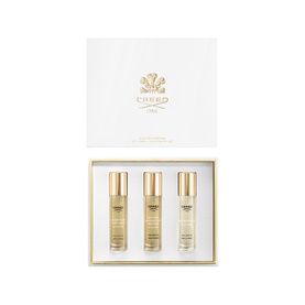 Creed Fragrance Set featuring three gold-capped miniature bottles presented in an open white and gold gift box