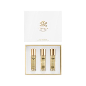 Creed Fragrance Set with three gold-capped travel spray bottles presented in a white and gold gift box.