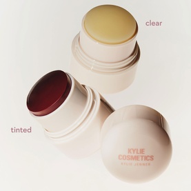 Kylie Cosmetics Skin Soother balm duo showing tinted burgundy and clear variants in cream compact packaging with gold lids