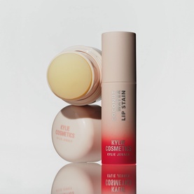 Kylie Cosmetics Lip Stain and balm duo displayed upright and open, showing yellow balm pot alongside red-toned lip stain stick