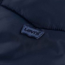Levi's children's outerwear in Naval Academy navy, close-up of tonal batwing logo patch on quilted fabric