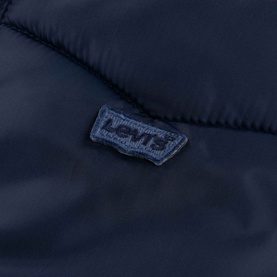 Levi's children's outerwear in Naval Academy navy, close-up of embroidered batwing logo patch on quilted fabric