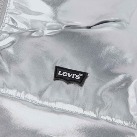Levi's children's silver metallic puffer jacket close-up showing quilted texture and branded Levi's batwing logo patch