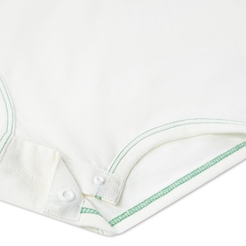 Levi's baby set in white with green contrast stitching detail, snap fastening visible at hem corner.