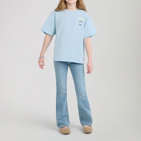 Model wearing Levi's Angel Falls blue oversized T-shirt with chest logo, styled with light wash flared jeans and beige sandals