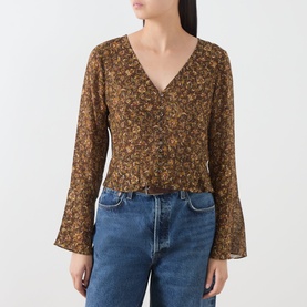 Model wearing Paige Hickory Multi floral silk blouse with V-neck, button front, long fluted sleeves and smocked waist, styled with blue jeans.