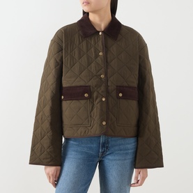 Model wearing Paige fern quilted jacket with corduroy collar and contrast brown pocket trim, styled with blue jeans