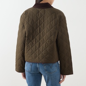 Model wearing Paige fern quilted jacket, back view, styled with blue jeans and dark roll-neck top