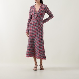 Model wearing Self-Portrait Red Check Knit Dress, long-sleeve midi length with button front detail and frayed hem, styled with black strappy heels.