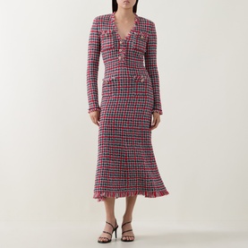 Model wearing Self-Portrait Red Check Knit Dress with long sleeves, V-neckline, patch pockets, and frayed hem, styled with black strappy heels.