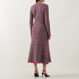 Model wearing Self-Portrait Red Check Knit Dress, back view, long sleeves, midi length with frayed hem, styled with black heeled sandals.