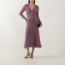 Model wearing Self-Portrait Red Check Knit Dress, long-sleeve tweed midi with frayed hem, styled with black strappy heels and small clutch bag